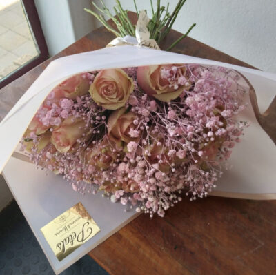 Small-wrapped-bouquet-petals-gourmet-flowers A small-sized bouquet of flowers wrapped in luxurious paper and tied with ribbon by Petals Gourmet Flowers.