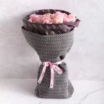 Fresh bouquet wrapped in Petals tissue paper and covered with a tweed wrap, arranged by Petals Gourmet Flowers.