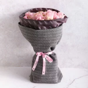Fresh bouquet wrapped in Petals tissue paper and covered with a tweed wrap, arranged by Petals Gourmet Flowers.